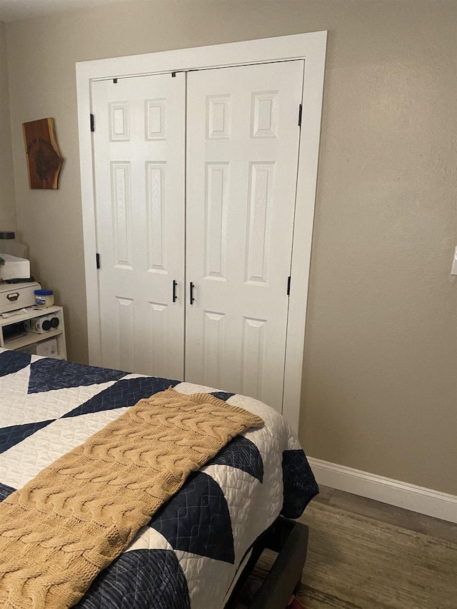 6033 Stones Throw Dr, Silsbee, TX 77656 - bedroom with wood finished floors, baseboards, and a closet