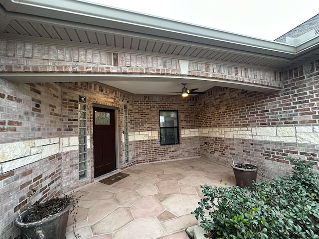 doorway to property with ceiling fan and a patio area