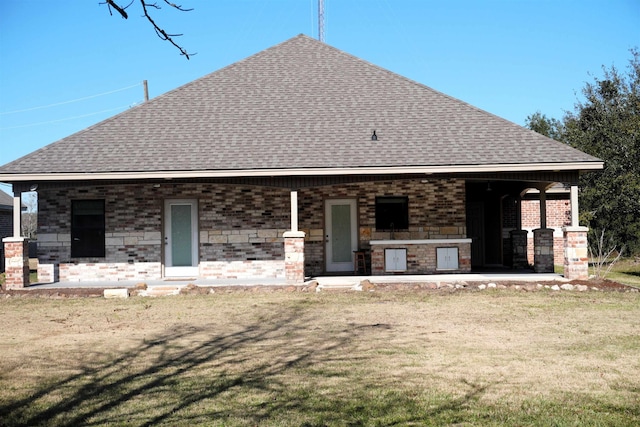 rear view of house featuring a yard