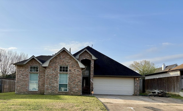 traditional-style house featuring a garage, brick siding, fence, concrete driveway, and a front lawn