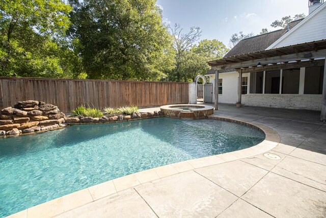 view of pool featuring a patio area and an in ground hot tub