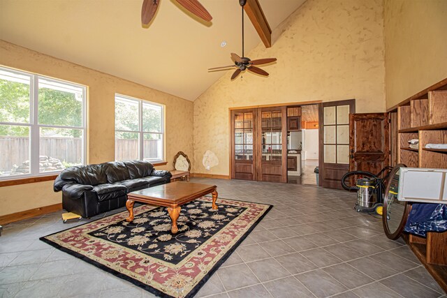 living room with tile patterned flooring, beam ceiling, high vaulted ceiling, and ceiling fan