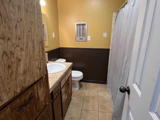 bathroom featuring tile patterned flooring, vanity, and toilet