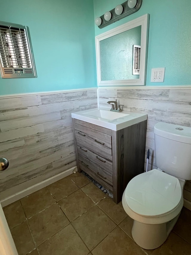 bathroom featuring tile patterned flooring, vanity, and toilet