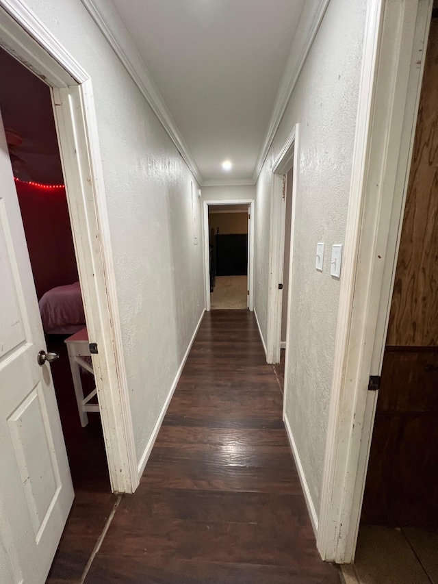 hall featuring dark wood-type flooring and ornamental molding