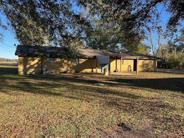 rear view of property with a lawn