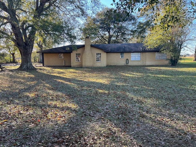 view of property exterior featuring a lawn