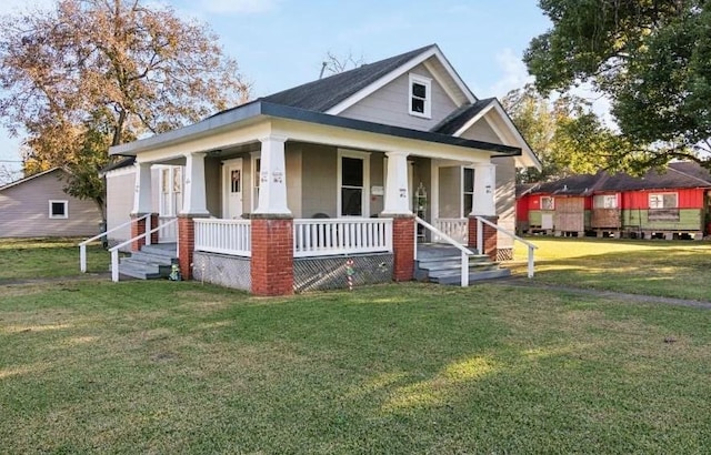 bungalow-style home featuring covered porch and a front yard