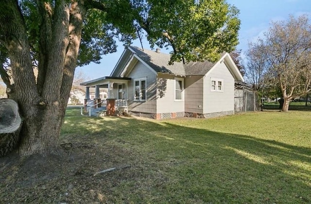 rear view of property with a porch and a yard