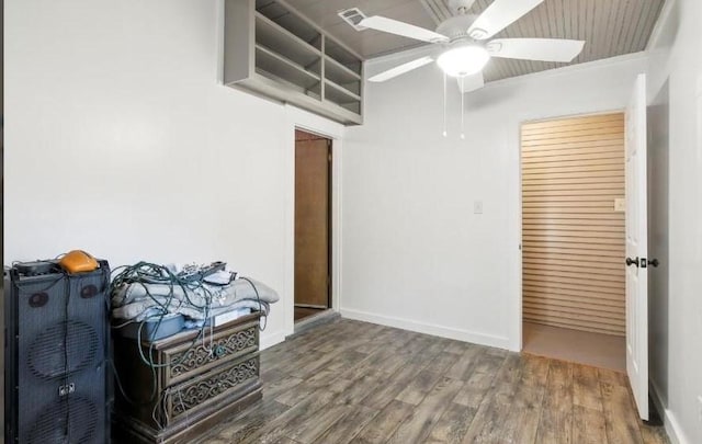 empty room with hardwood / wood-style flooring, ceiling fan, and crown molding