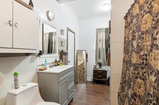 bathroom featuring crown molding, toilet, vanity, and hardwood / wood-style flooring