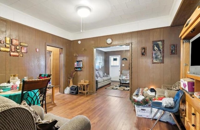 interior space with hardwood / wood-style floors and wood walls