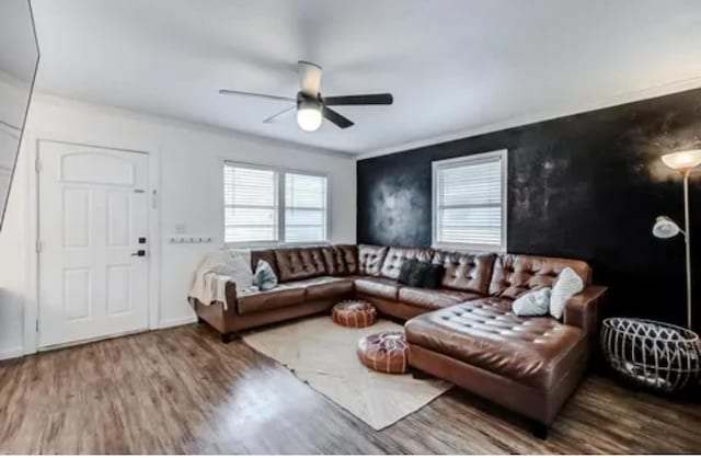 living room featuring hardwood / wood-style floors and ceiling fan