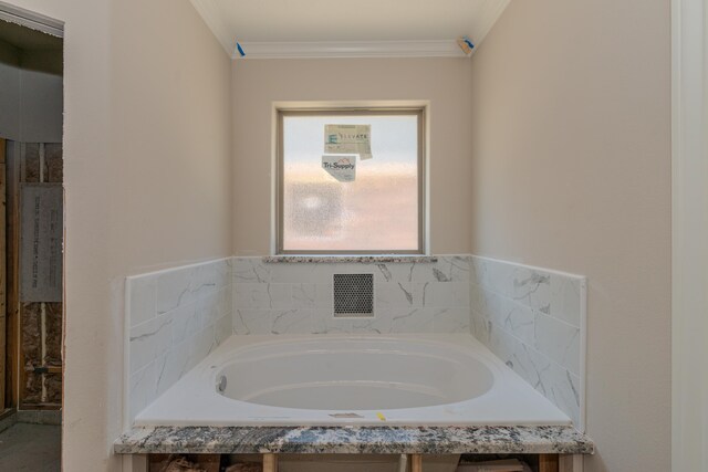 bathroom with tiled bath and crown molding