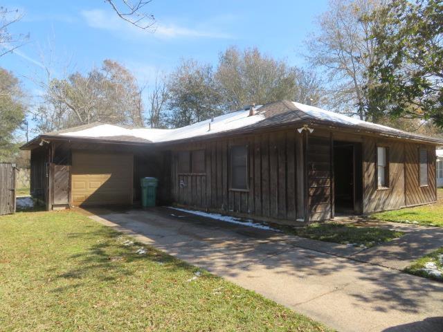 view of home's exterior with a garage and a lawn