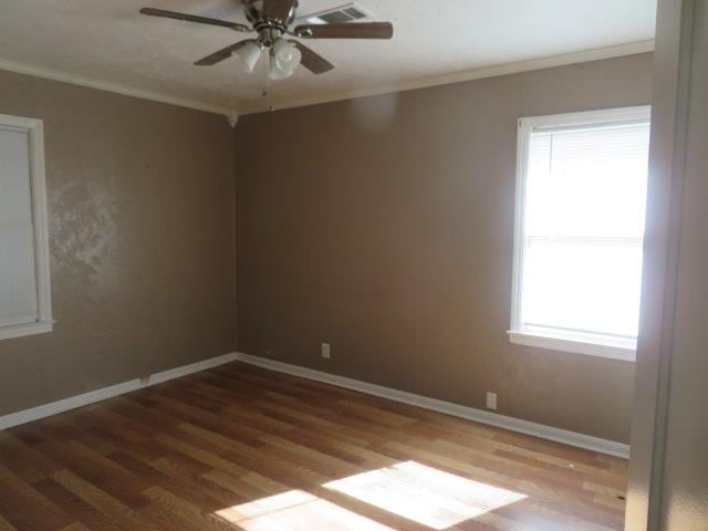 unfurnished room with wood-type flooring, ornamental molding, and ceiling fan