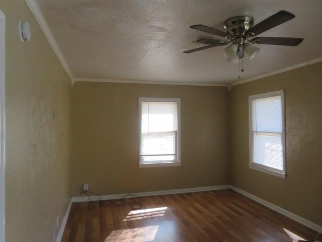 spare room featuring ornamental molding, dark hardwood / wood-style floors, and ceiling fan