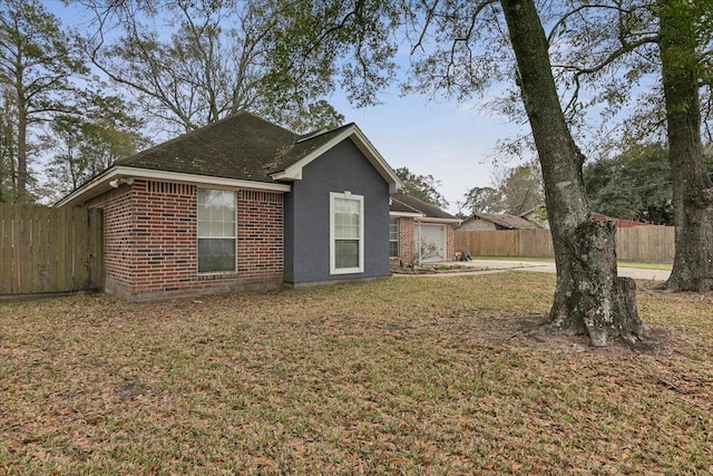 view of side of property with a lawn