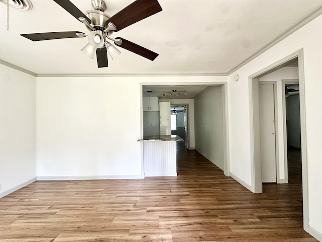 312 Temple, Woodville, TX 75979 - empty room featuring wood finished floors, a ceiling fan, and ornamental molding