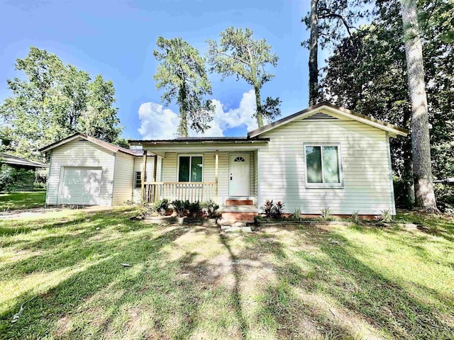 312 Temple, Woodville, TX 75979 - ranch-style house with a porch, an attached garage, and a front lawn