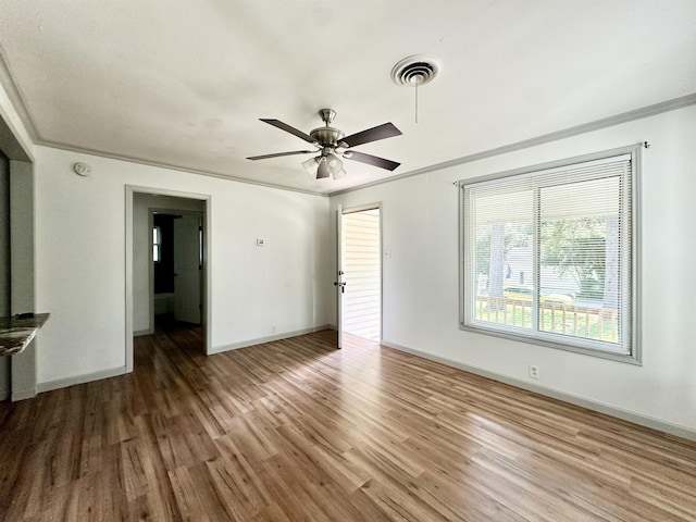 312 Temple, Woodville, TX 75979 - unfurnished living room featuring wood finished floors, ceiling fan, and ornamental molding