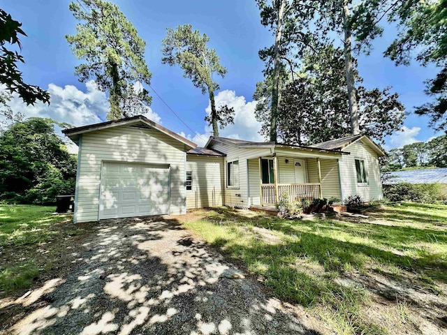 312 Temple, Woodville, TX 75979 - ranch-style house featuring a porch, an attached garage, and driveway