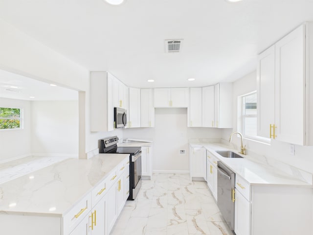 kitchen featuring marble finish floor, stainless steel appliances, visible vents, a sink, and light stone countertops