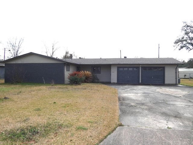 ranch-style house featuring a garage and a front yard