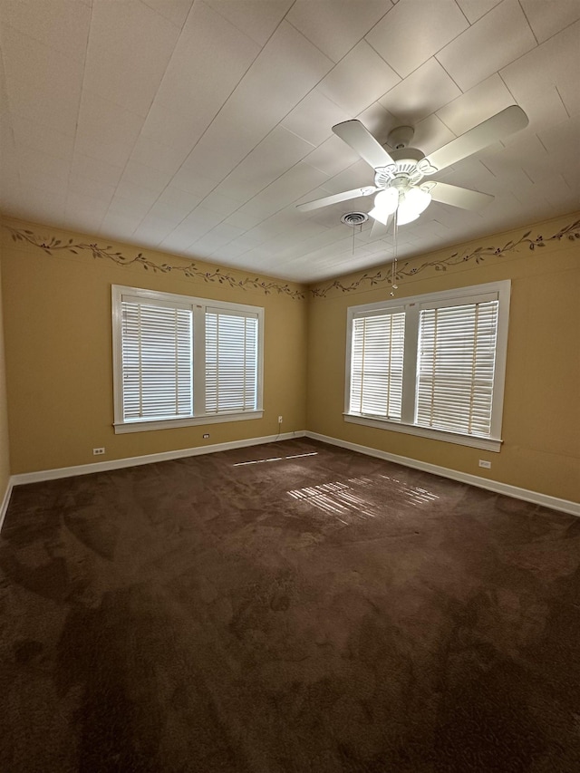 carpeted spare room featuring ceiling fan