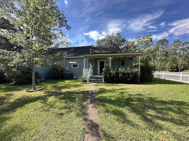 ranch-style home with a front yard, a porch, and cooling unit