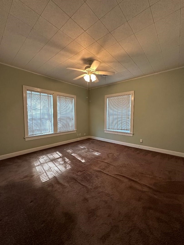 carpeted empty room with ceiling fan and ornamental molding