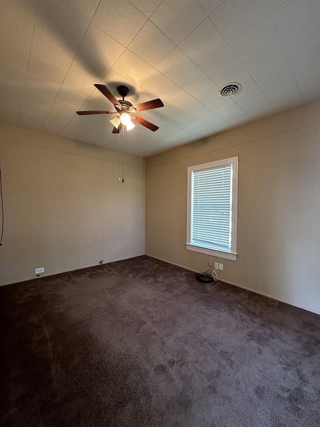 carpeted spare room with ceiling fan