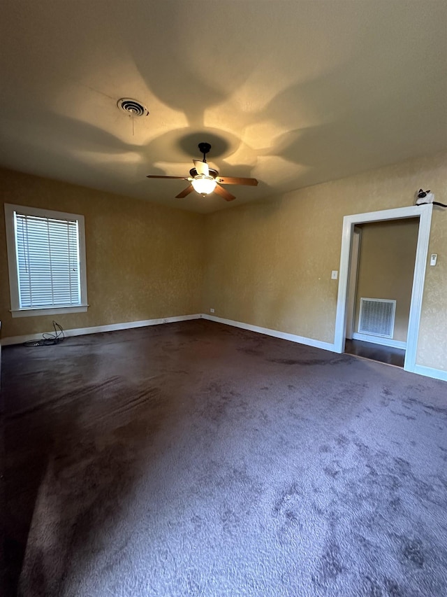 carpeted spare room with ceiling fan