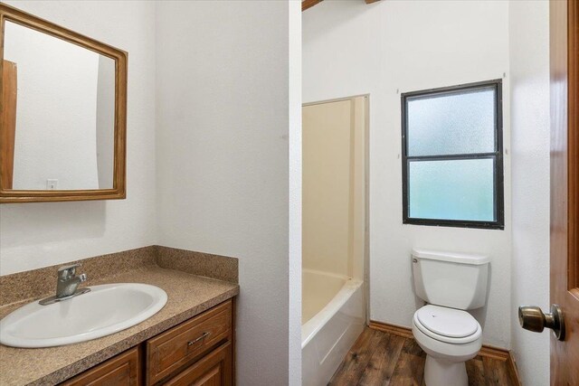 full bathroom with wood-type flooring, vanity, toilet, and separate shower and tub