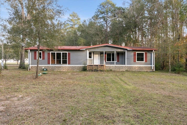 manufactured / mobile home featuring covered porch and a front yard