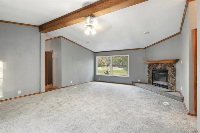 unfurnished living room with ceiling fan, a stone fireplace, lofted ceiling with beams, light carpet, and ornamental molding