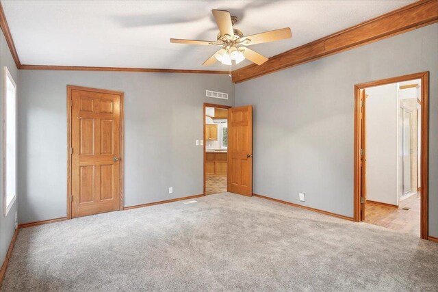 unfurnished bedroom featuring light carpet, multiple windows, vaulted ceiling, and ceiling fan