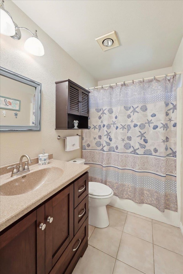 7385 Hidden Valley Dr, Beaumont, TX 77706 - full bathroom featuring toilet, vanity, and tile patterned floors