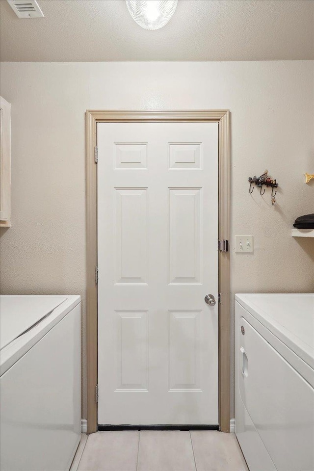 7385 Hidden Valley Dr, Beaumont, TX 77706 - laundry area with light tile patterned floors and washing machine and dryer