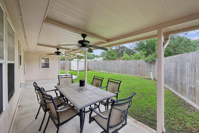 7385 Hidden Valley Dr, Beaumont, TX 77706 - view of patio / terrace with a ceiling fan, outdoor dining area, and an outbuilding
