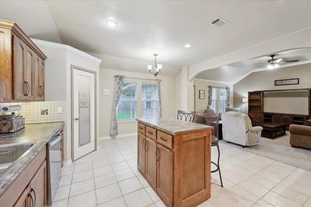 7385 Hidden Valley Dr, Beaumont, TX 77706 - kitchen featuring vaulted ceiling, a breakfast bar area, a chandelier, dishwasher, and decorative backsplash