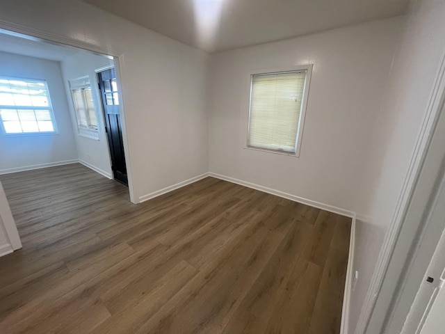 unfurnished room with dark hardwood / wood-style floors