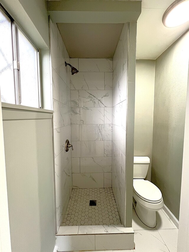 full bath featuring a shower stall, toilet, and baseboards