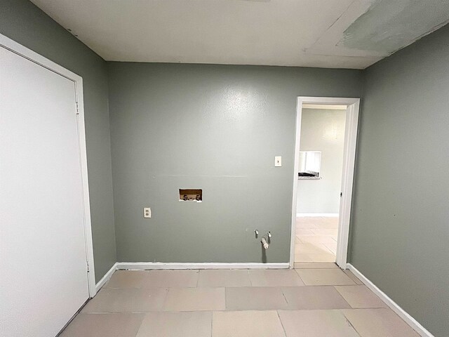 laundry room featuring light tile patterned flooring, laundry area, hookup for a washing machine, and baseboards