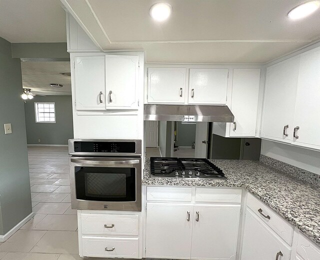 kitchen with under cabinet range hood, appliances with stainless steel finishes, and white cabinetry
