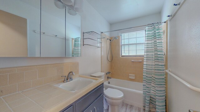 full bathroom featuring vanity, shower / tub combo, backsplash, and toilet