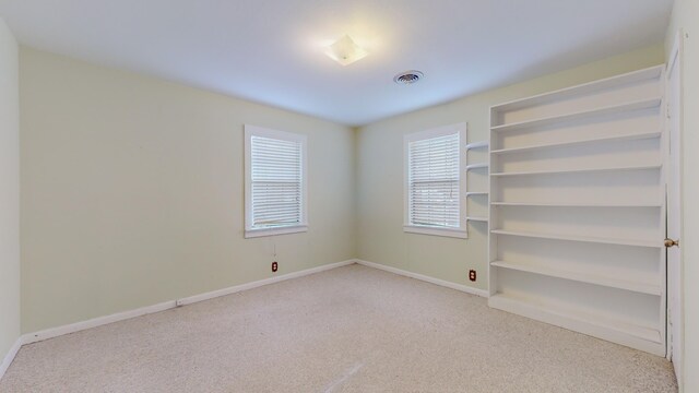 spare room featuring light colored carpet