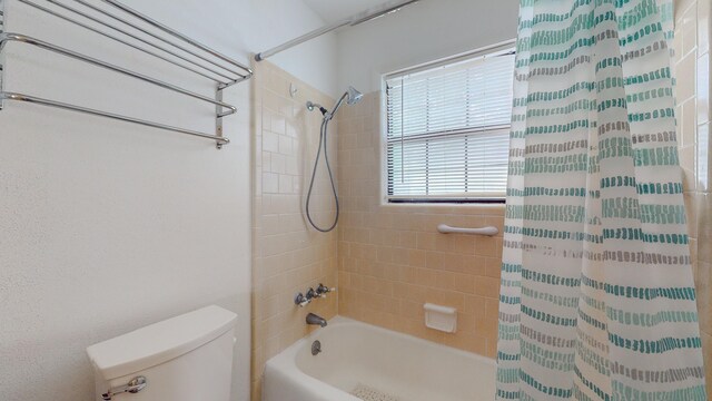 bathroom with shower / tub combo and toilet