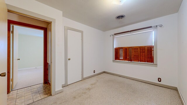 unfurnished bedroom featuring light colored carpet