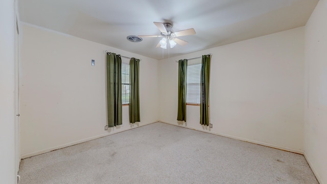 carpeted empty room featuring ceiling fan